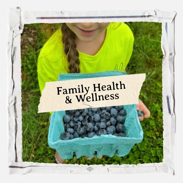 Family Health & Wellness - little girl holding a blue box of blueberries